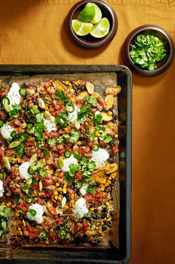 Nachos med topping serverad med lime och koriander.