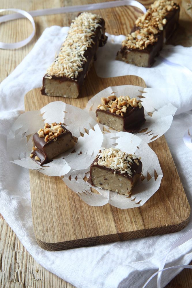 Chokladbitar med nötter och kokos på skärbräda.